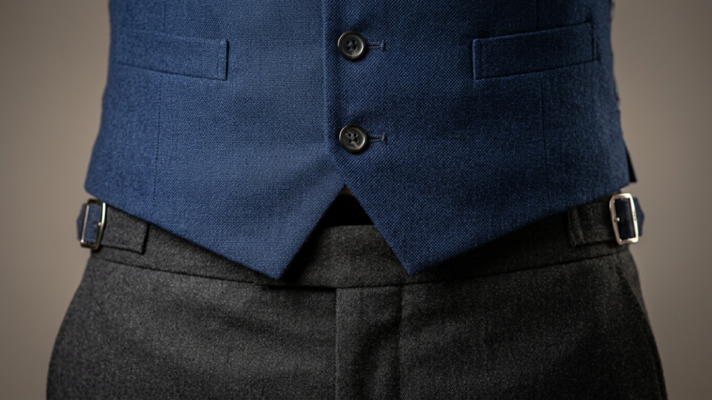Close-up of perfectly fitted waistcoat showing flat button closure and clean waistband coverage on a 3 piece suit